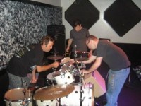 Setting up the drums.... Robert D., Paul and the Backline Tech