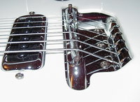 460 Bridge.  The side in the foreground is slightly under the pick guard, rather than just in the cut-out.