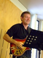 A middle-aged dude with a real nice guitar