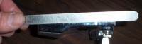 A straight edge rule against the bottom of tailpiece: it's flat.