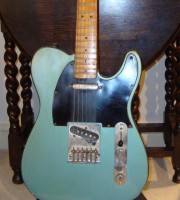 The original bridge plate and the screws on the outside of the pickguard.