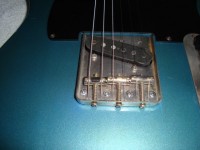The new bridge and strings now threaded through the body