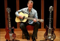 Jim Irsay, the Colts' owner, on the performance stage at his home with guitars from his collection: George Harrison's Gibson SG , left, and Jerry Garcia's Tiger.