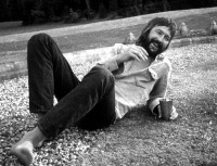 Relaxed: Eric drinks in the garden of Pattie and George's Friar Park home