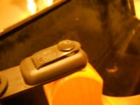 Close the hood and snap the latch.  It hangs free to move around the thinnest part of the button like a loose bearing.