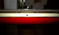 Big Red's Binding; medium-tall frets over the top edge of the binding, as I requested. Note the crown/profile of the dressed frets; Larry did a great job of tapering them at the top and the frets are a joy to play and do not have  a wide, or fat feel to them as some larger frets do when dressed differently.