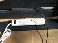 Power strip attached to the back side of the headboard