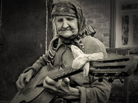 Old-woman-playing-guitar.jpg