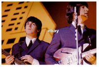 "This dazzling color photo of PAUL McCARTNEY and JOHN LENNON is unusual in that it shows John using for one of only a few times his "Sunburnt" Rickenbacker-325 Fire-glo, for The Beatles' 1965 Christmas Show."