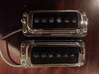 Top pickup's chrome surround cutout has straight sides. Bottom has barrel-shaped sides.