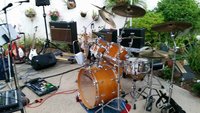 Al's drum kit nestled between the banks of amps