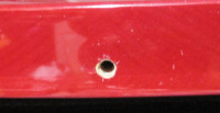 Accent strap button (hole) close to bottom
