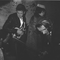 &quot;Because the Fourmost were more comedic (ie. had a laf on stage) they were one of the few groups that my brother and his chums mixed with on stage.  This image was taken from the back of the Cavern by the entrance steps at a Christmas do with Mike (4most) Millwall borrowing George's jacket, Brian (4most) O'Hara borrowing a violin and his mother's scarf, and George borrowing a dressing gown and someone's Christmas cracker hat.  I've just realised, sadly, none of these young men are now with us.&quot; - Mike McCartney