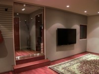 Vocal booth and media wall with in-wall speakers and studio wrap